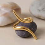Gold ring on a purple stone with a neutral background