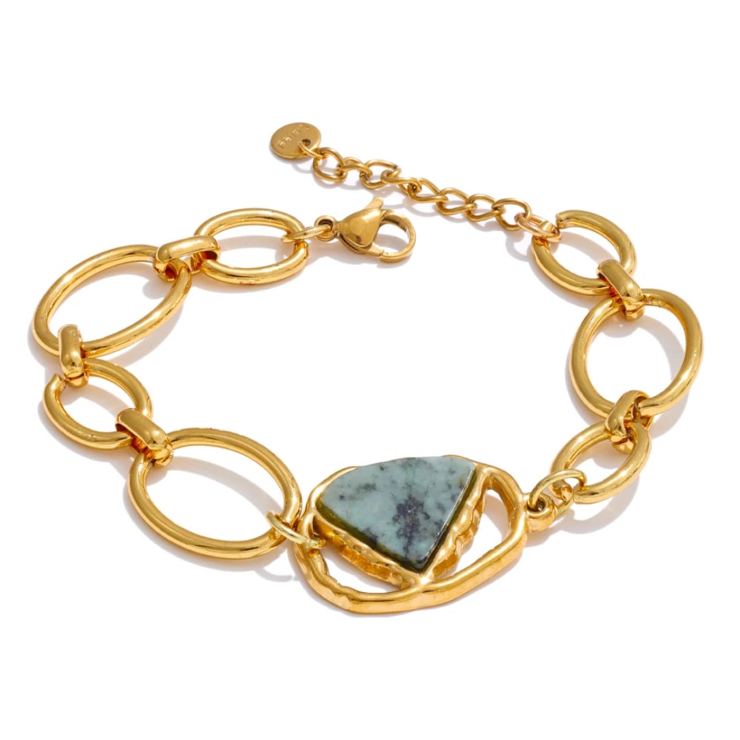 Gold chain bracelet with a green stone on a white background