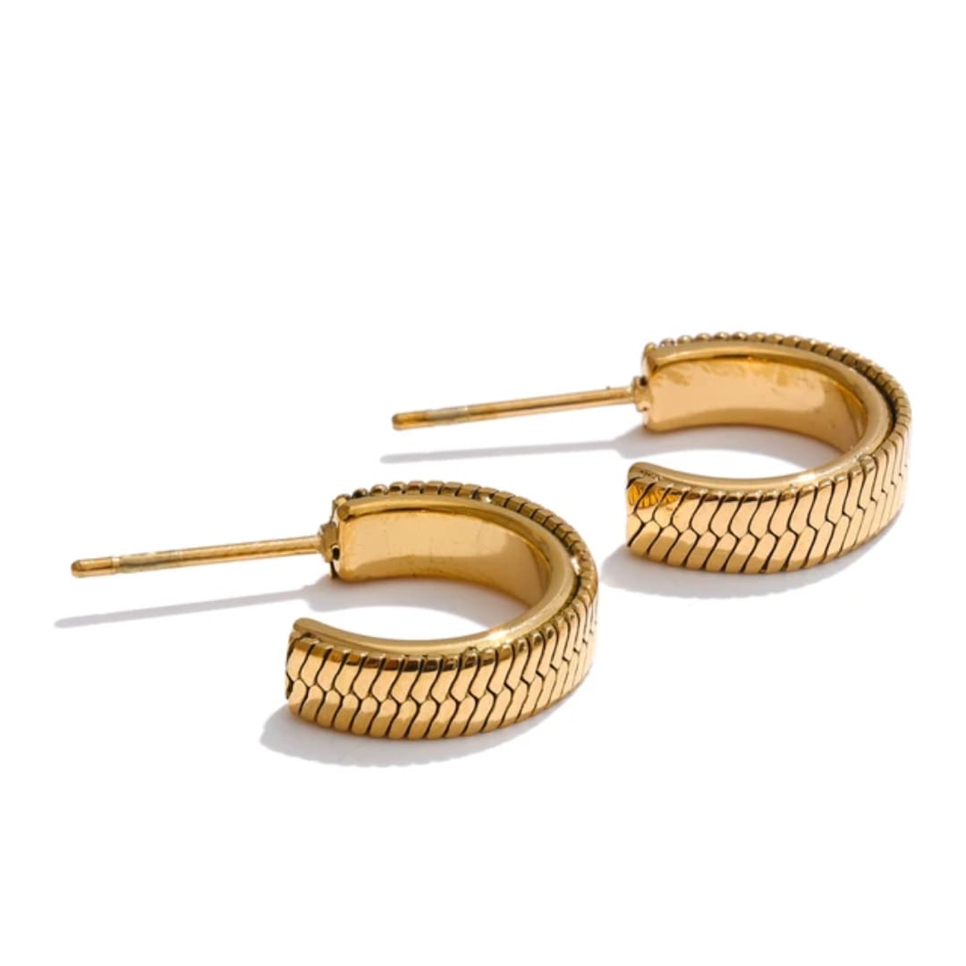 Pair of gold hoop earrings on a white background