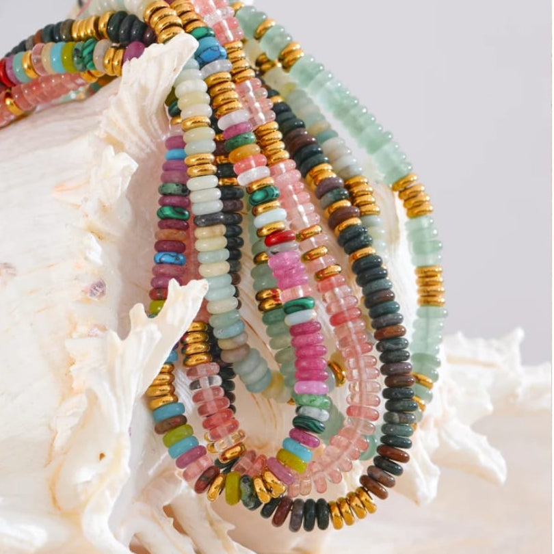 Colorful beaded bracelets on a white shell